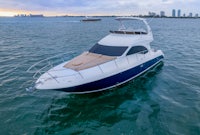 a white and blue motor boat in the ocean