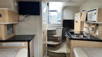 the interior of a boat with a sink and microwave