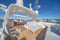 the deck of a yacht with a sofa and chairs