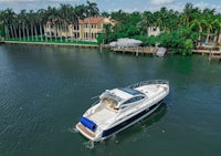 an aerial view of a boat in the water near a house