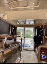 the interior of a boat with a couch and tv