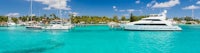 two boats docked at a dock in the turquoise water