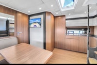 the interior of a boat with a table and tv