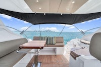 the interior of a boat with seating and a view of the ocean