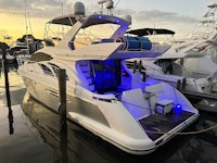 a white boat docked at a dock