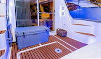 the interior of a yacht with a cooler on the floor